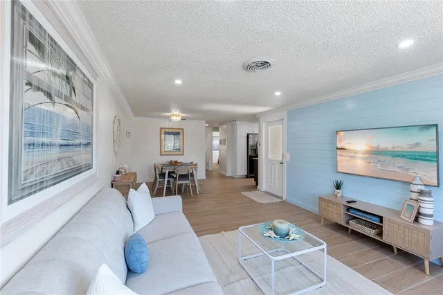 a living room with furniture a dining table and wooden floor