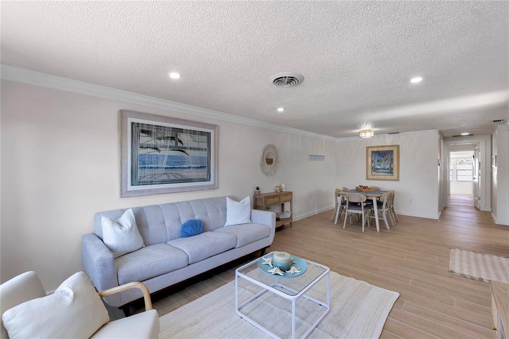 407 63rd Street Holmes Beach, FL 34217 - Photo 6 of 33 a living room with furniture a dining table and wooden floor