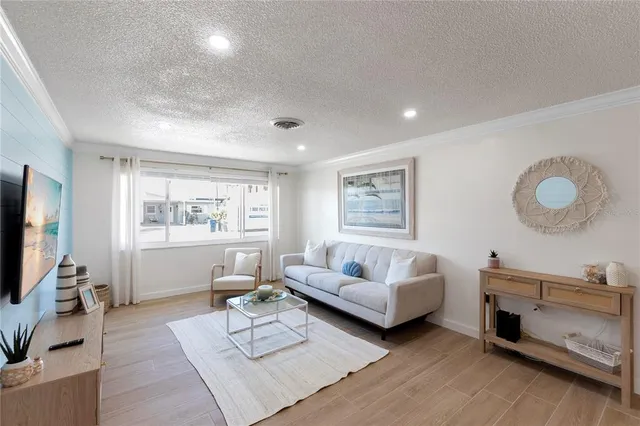 a large room with kitchen island granite countertop a sink and a large window