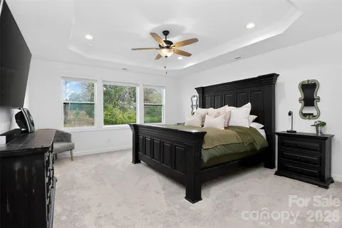 a spacious bathroom with double vanity a mirror a bathtub shower sink and