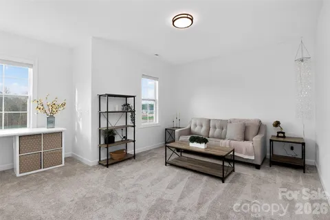 a living room with furniture and floor to ceiling window
