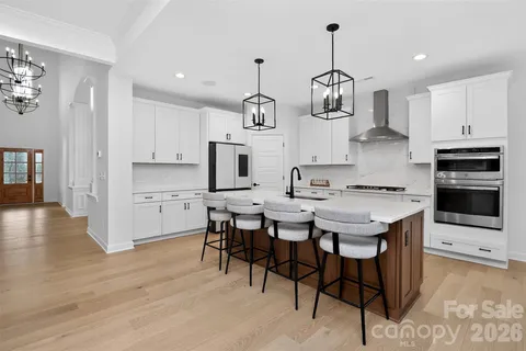 a kitchen with stainless steel appliances kitchen island a sink and a refrigerator