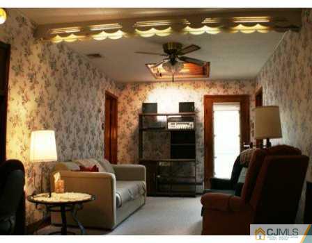 24 Baxter Road Edison, NJ 08817 - Photo 2 of 7 a living room with furniture and chandelier