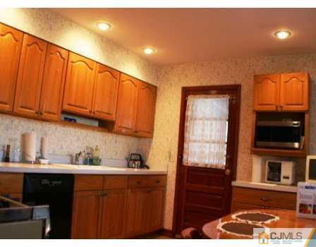 24 Baxter Road Edison, NJ 08817 - Photo 3 of 7 a kitchen with stainless steel appliances granite countertop a refrigerator and a stove top oven