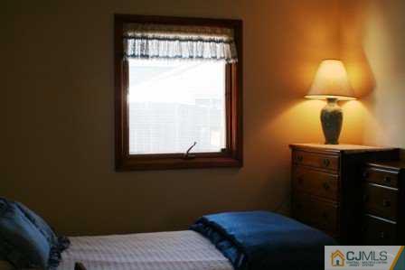 24 Baxter Road Edison, NJ 08817 - Photo 4 of 7 a bedroom with a bed and a lamp next to a window