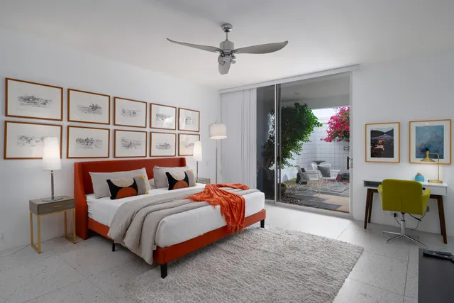 a bedroom with a bed mirror and window