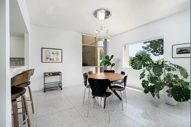 a dining room with furniture and a chandelier