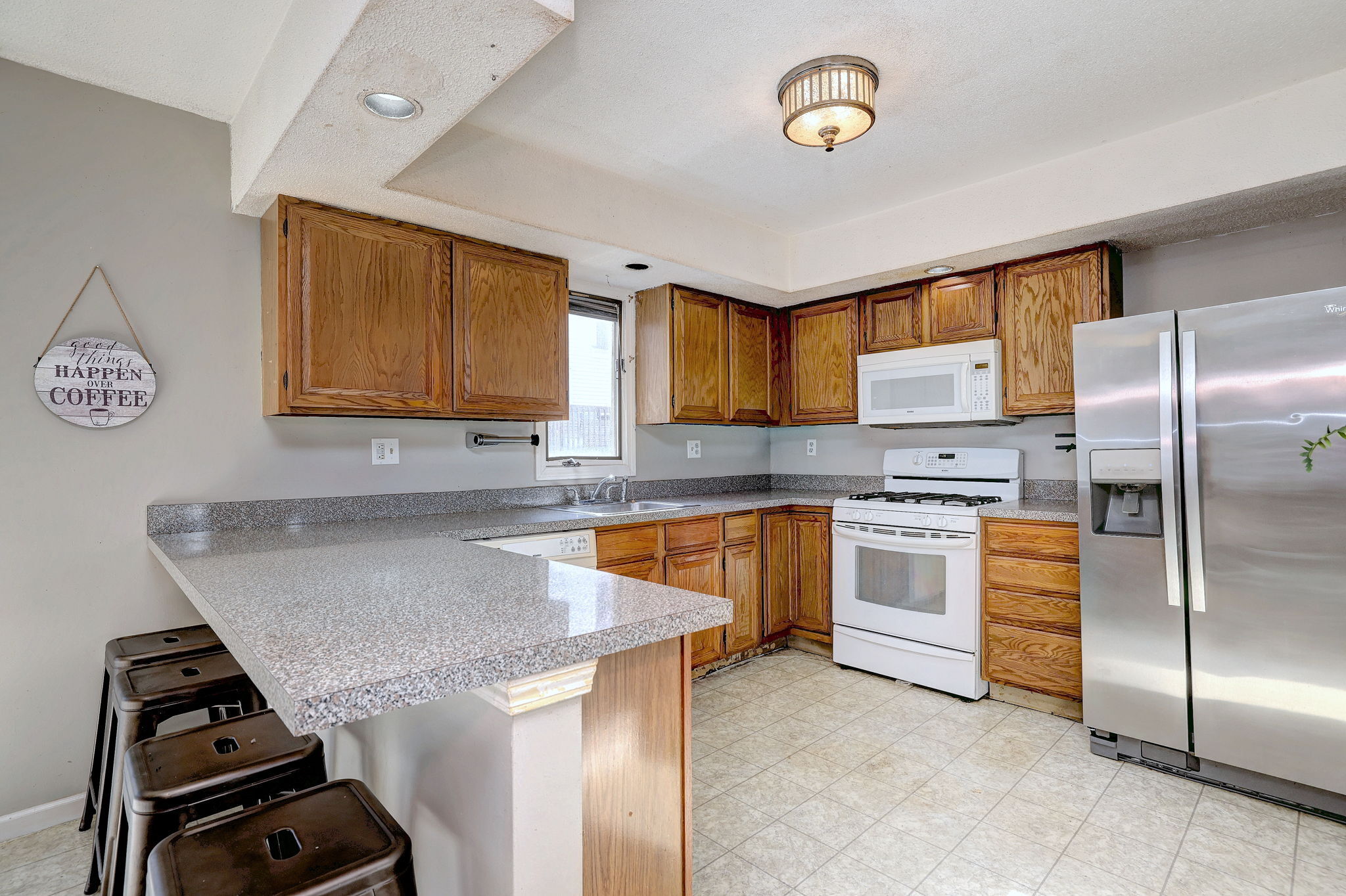 1480 Capitol Avenue, Unit H811 Bridgeport, CT 06604 - Photo 13 of 39 a kitchen with a refrigerator and a stove top oven