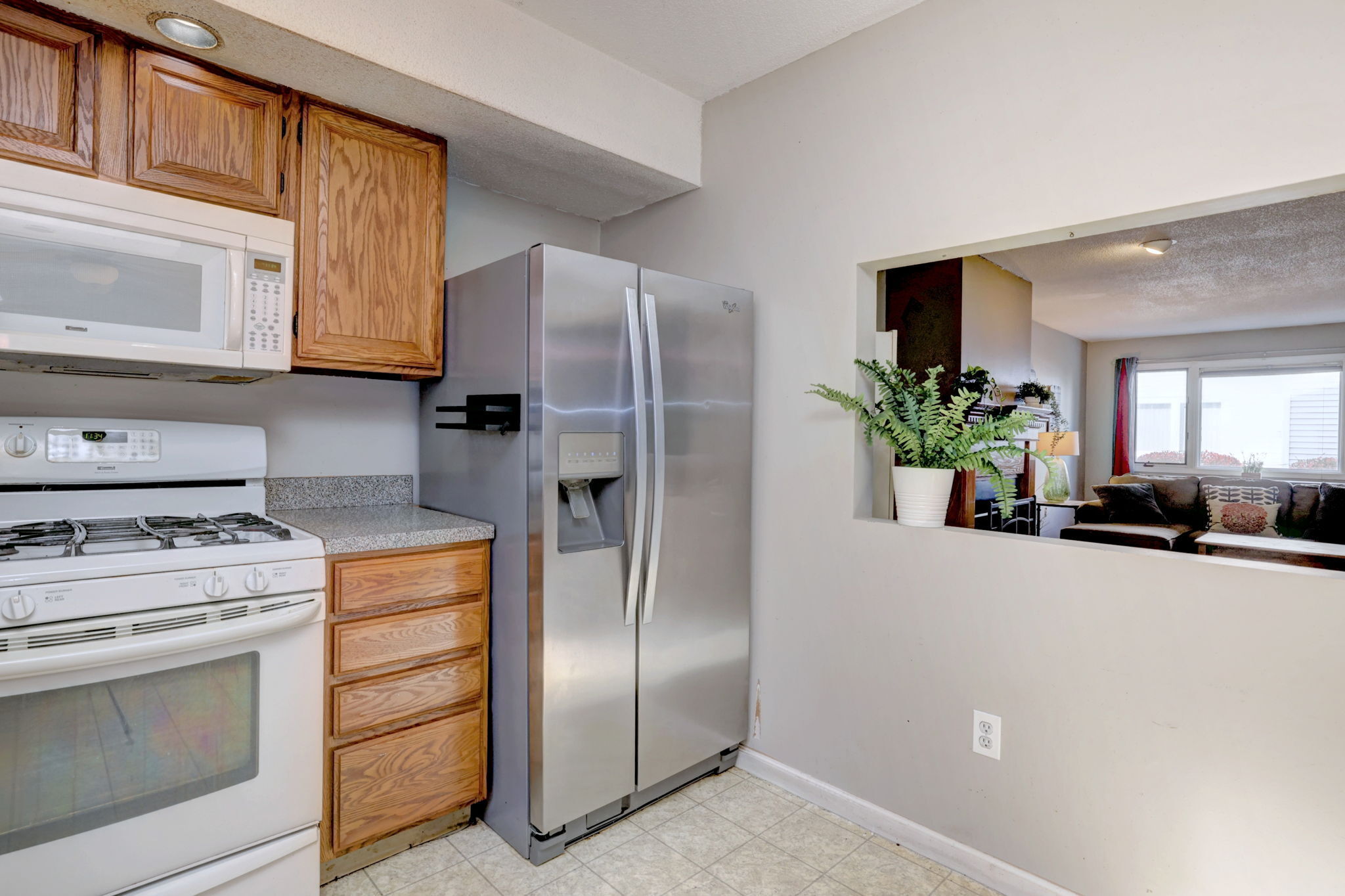 1480 Capitol Avenue, Unit H811 Bridgeport, CT 06604 - Photo 18 of 39 a kitchen with a refrigerator and a white cabinets