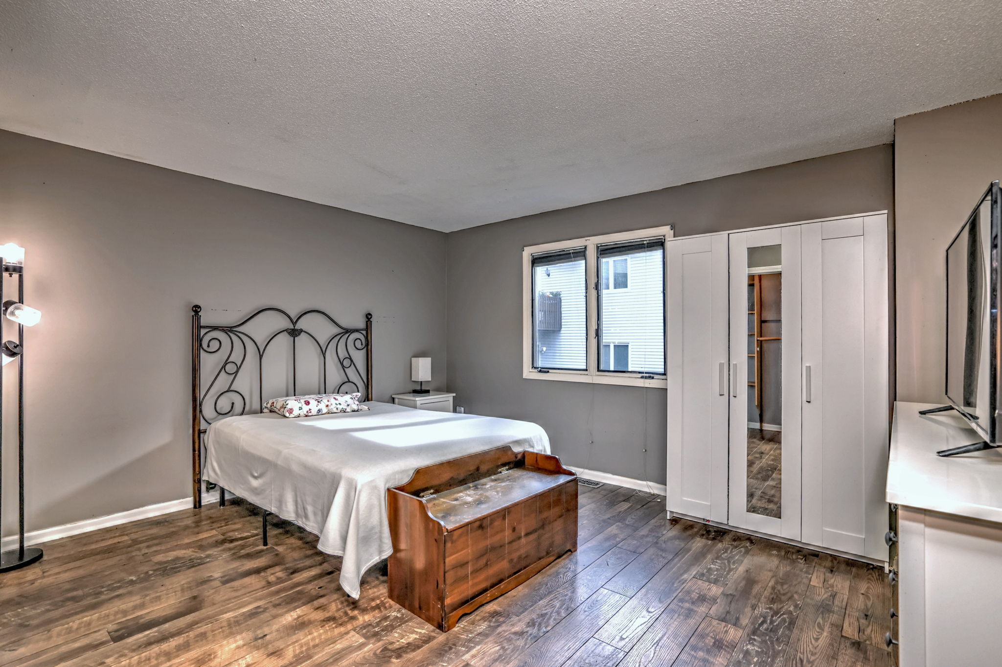 1480 Capitol Avenue, Unit H811 Bridgeport, CT 06604 - Photo 23 of 39 a bedroom with a bed a mirror and a window