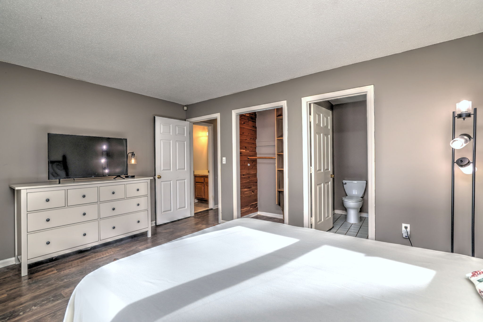 1480 Capitol Avenue, Unit H811 Bridgeport, CT 06604 - Photo 25 of 39 a bedroom with a bed and a flat screen tv in it