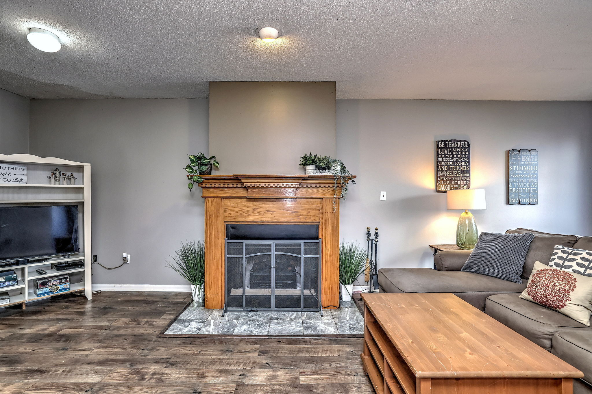 1480 Capitol Avenue, Unit H811 Bridgeport, CT 06604 - Photo 8 of 39 a living room with furniture a flat screen tv and a fireplace
