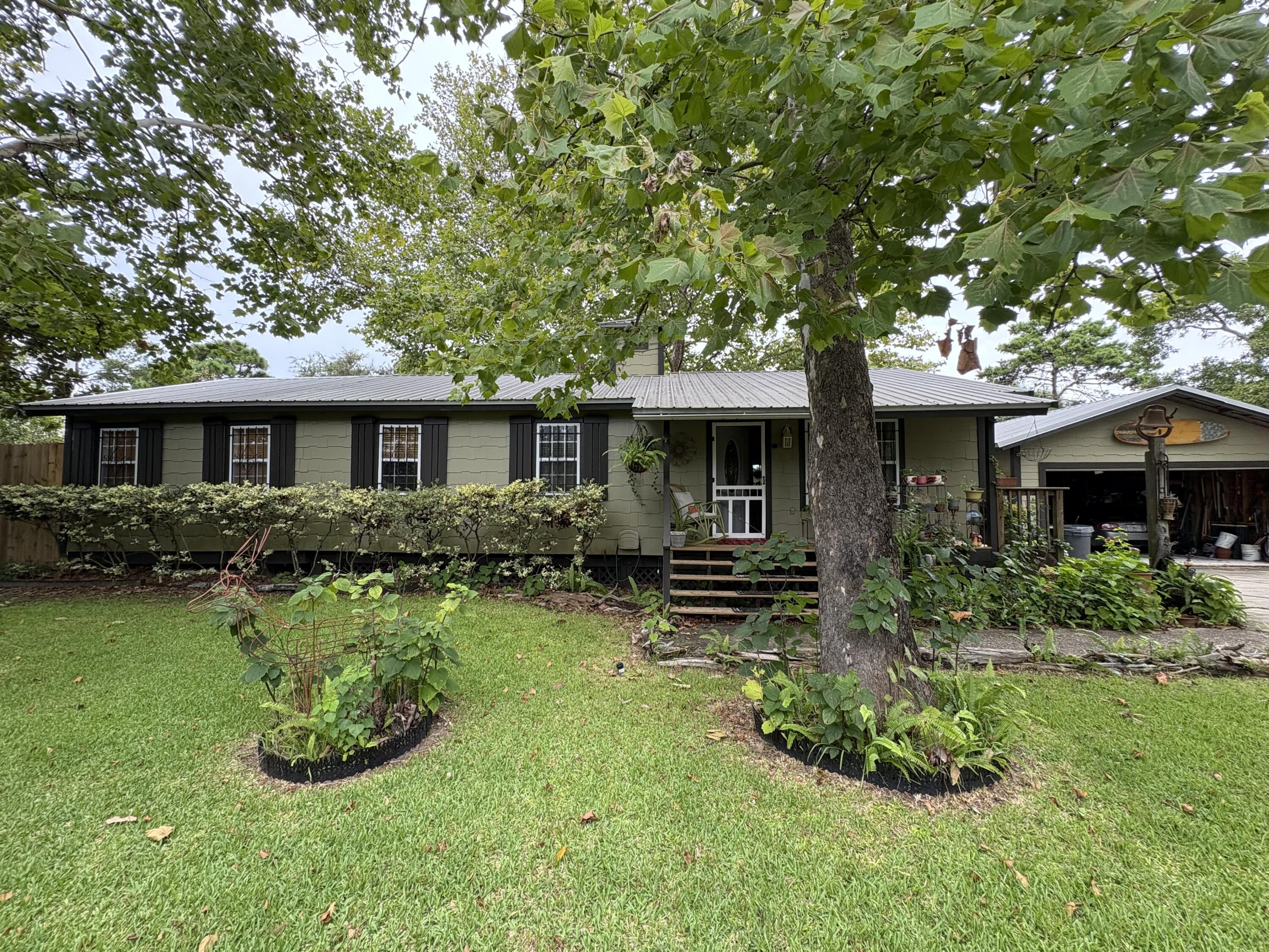 335 Acacia Street Santa Rosa Beach, FL 32459 - Photo 2 of 36 a view of a house with a yard and sitting area