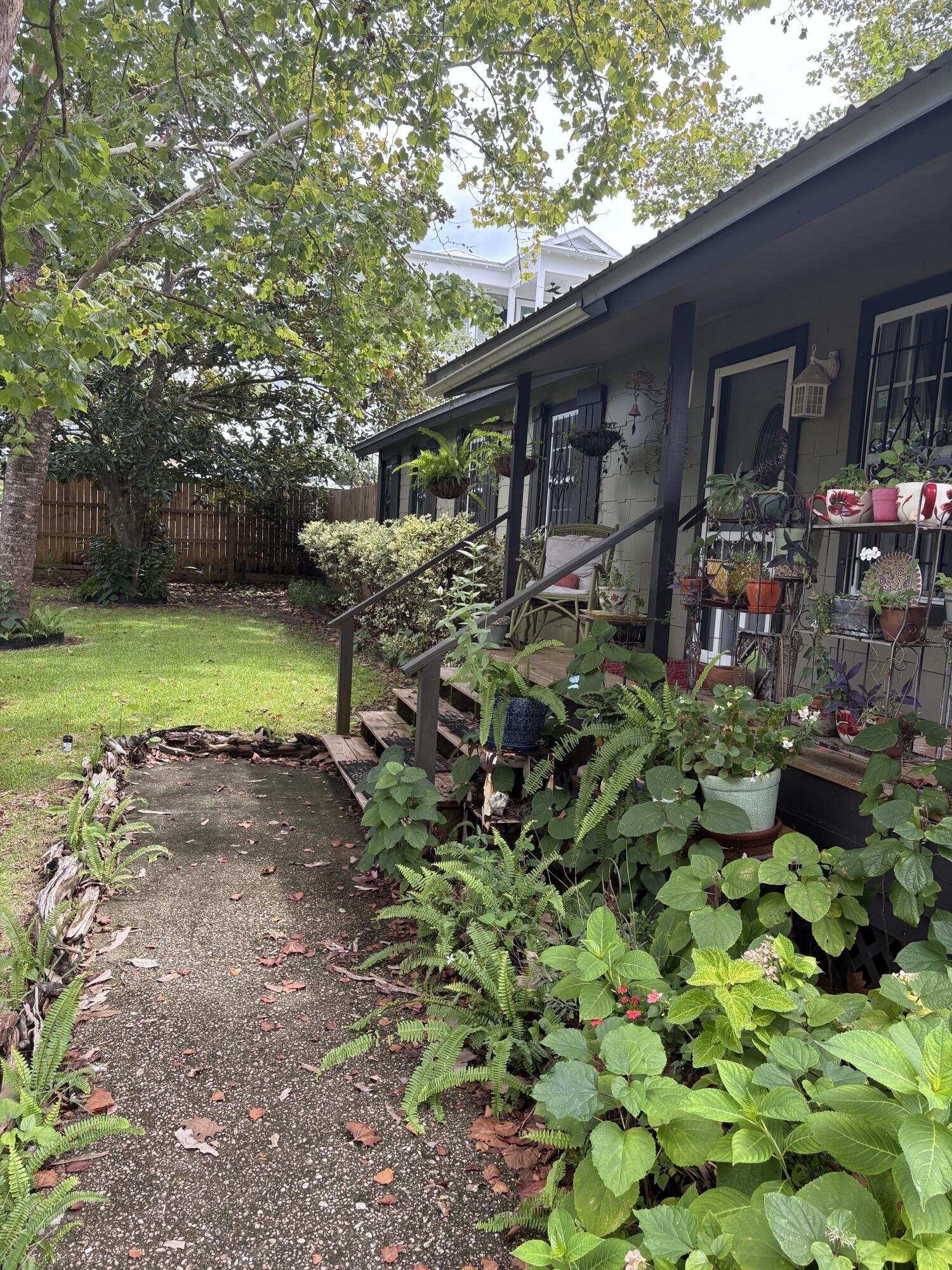 335 Acacia Street Santa Rosa Beach, FL 32459 - Photo 3 of 36 a backyard of a house with a yard and outdoor seating