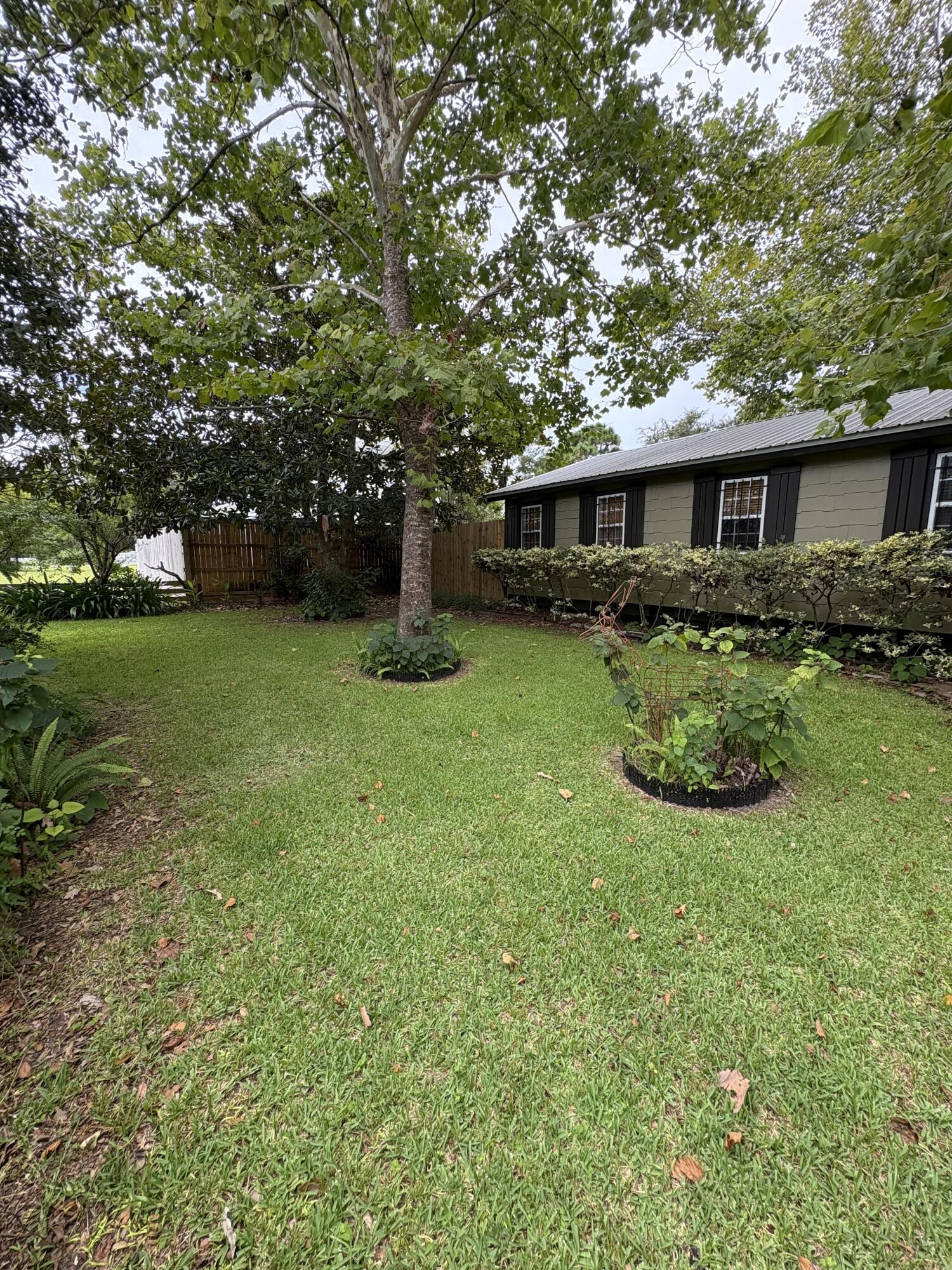 335 Acacia Street Santa Rosa Beach, FL 32459 - Photo 33 of 36 a front view of a house with garden