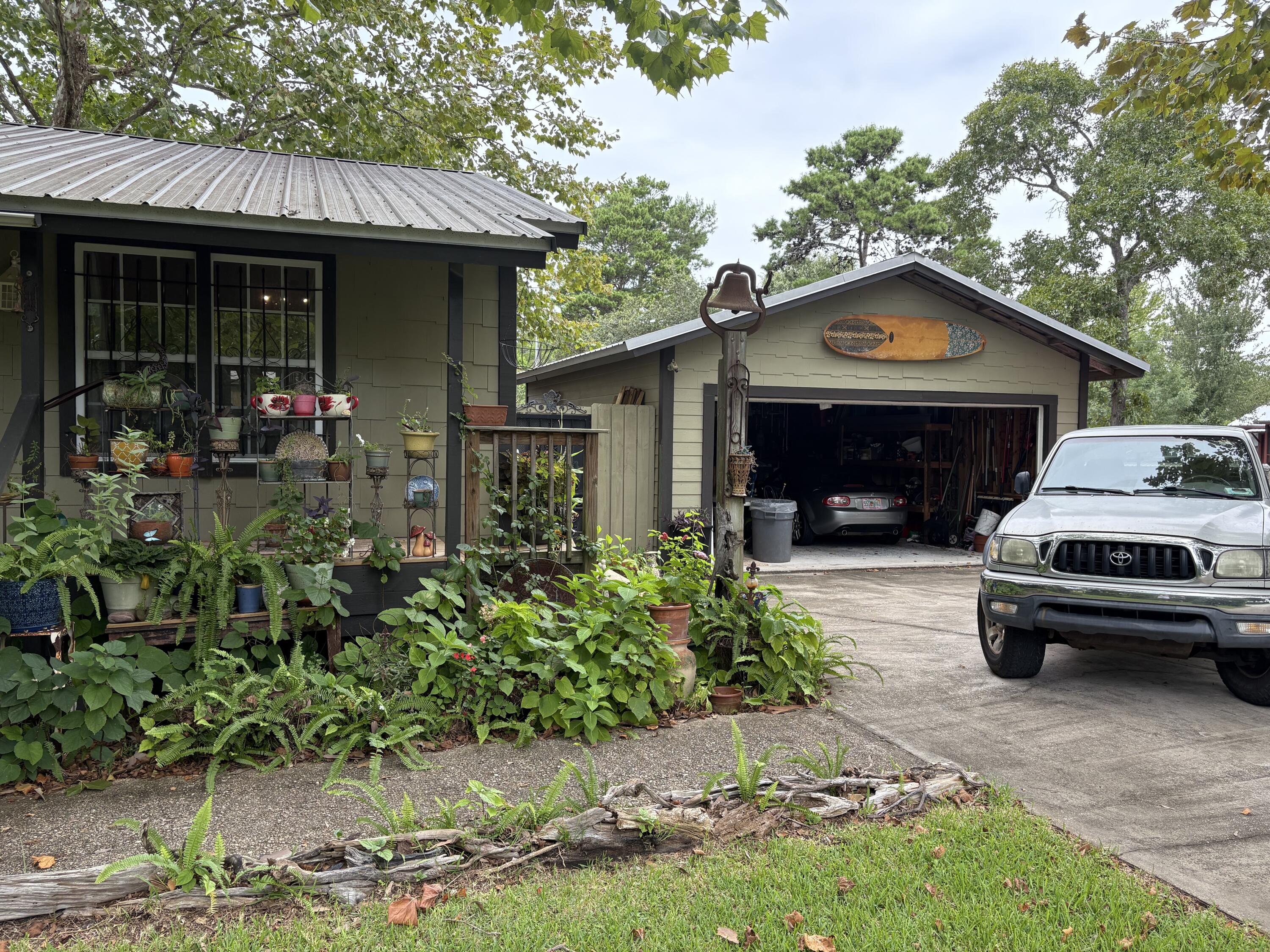 335 Acacia Street Santa Rosa Beach, FL 32459 - Photo 34 of 36 a front view of a house with garden