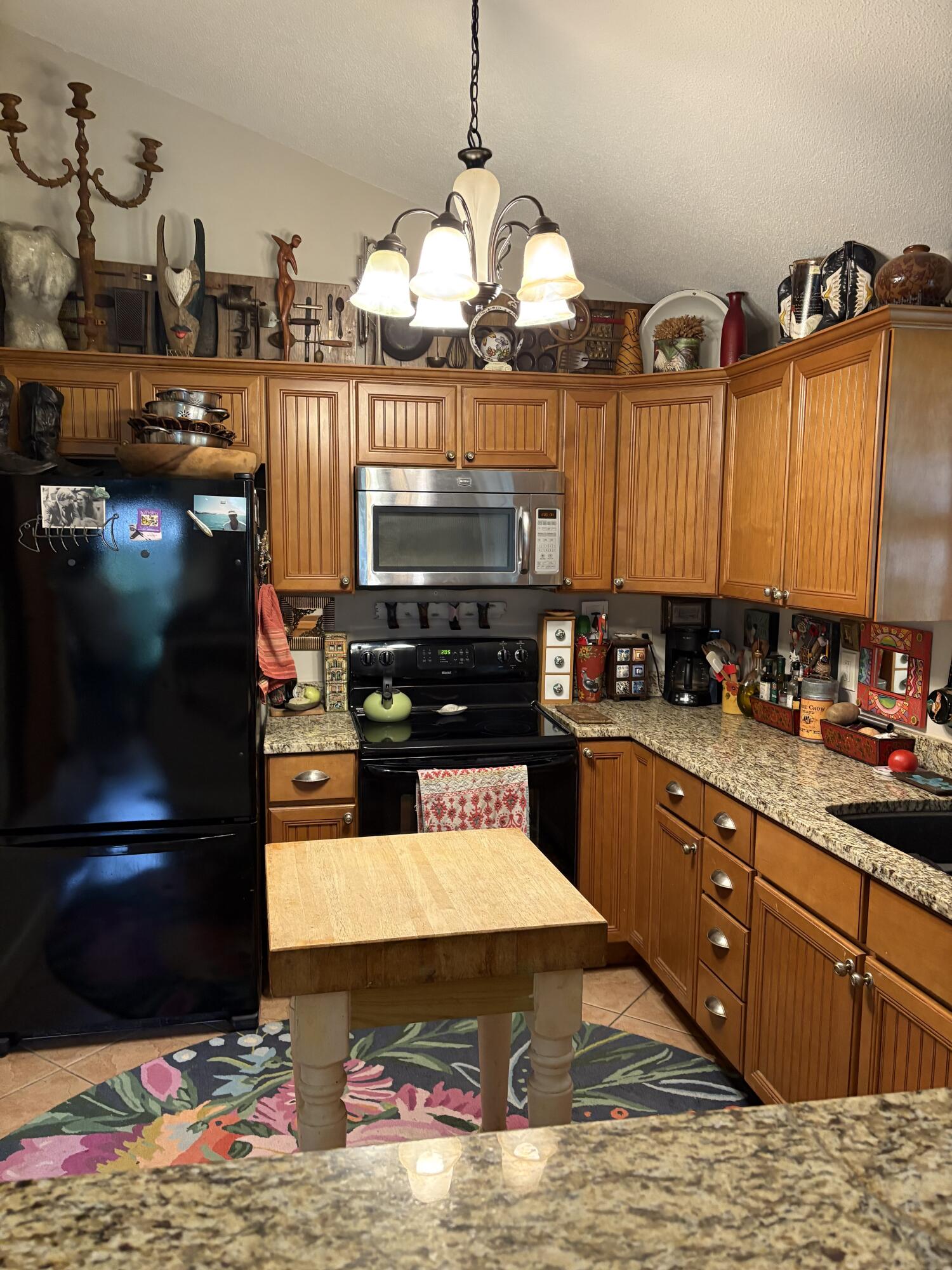 335 Acacia Street Santa Rosa Beach, FL 32459 - Photo 7 of 36 a kitchen with stainless steel appliances kitchen island granite countertop a refrigerator stove and sink