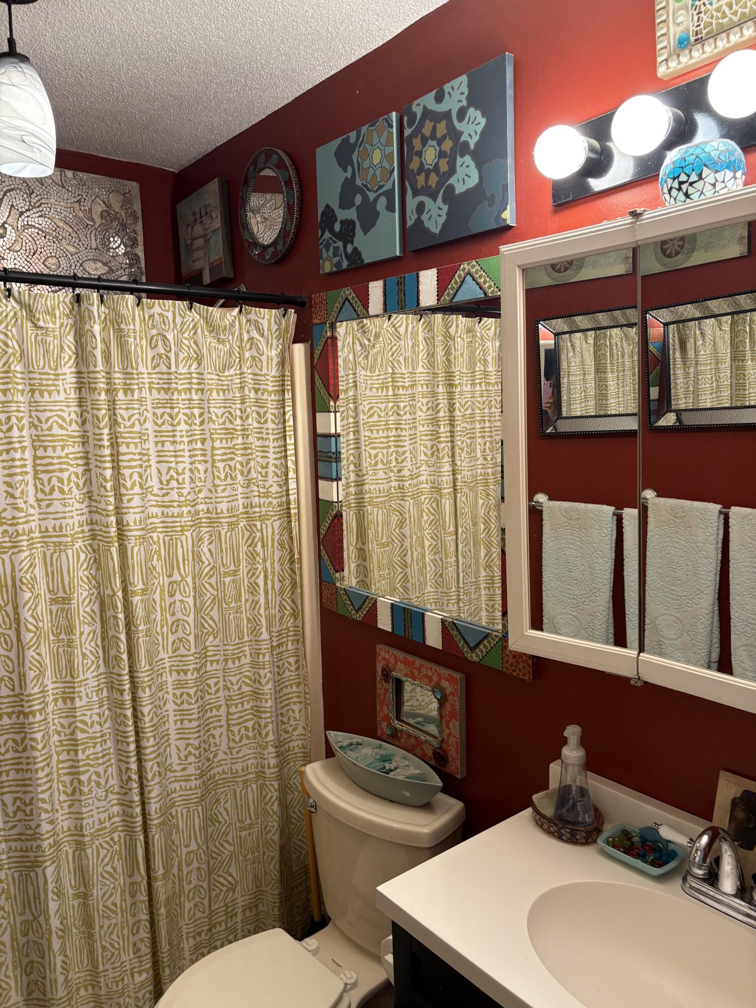 335 Acacia Street Santa Rosa Beach, FL 32459 - Photo 8 of 36 a bathroom with a sink a toilet and shower curtain