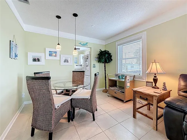a living room with furniture a flat screen tv and a window