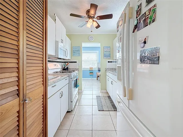 a bedroom with a bed chandelier and a window