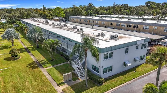 a view of a house with pool and sitting area