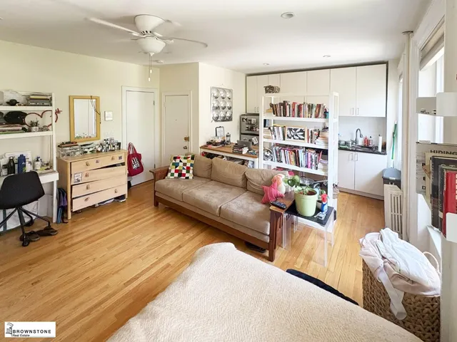 a living room with furniture and a book shelf