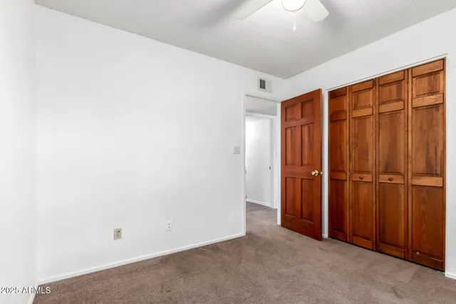 an empty room with closet area