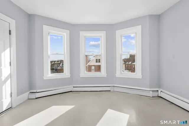 a kitchen with white cabinets and a stove