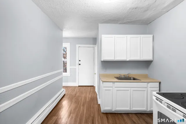 a kitchen with a stove and a refrigerator