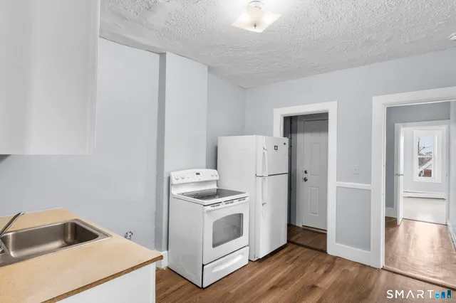 a white toilet sitting next to a bath tub