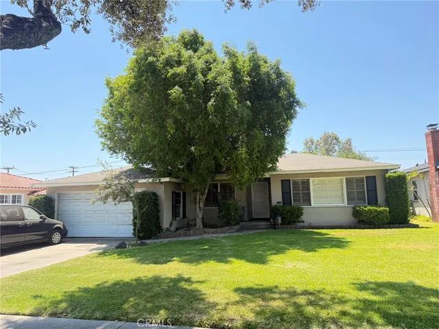 a view of a house with swimming pool and a yard