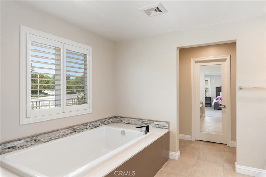 31134 Maverick Lane Temecula, CA 92591 - Photo 16 of 24 a bathroom with a tub a sink and a window