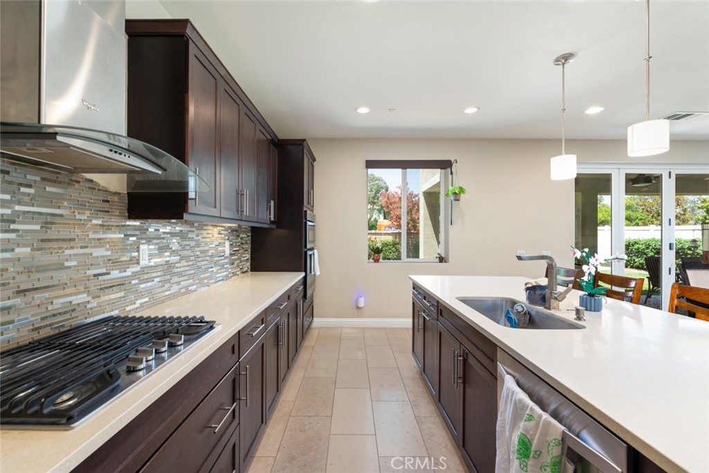 31134 Maverick Lane Temecula, CA 92591 - Photo 4 of 22 a kitchen with stainless steel appliances a sink stove and cabinets