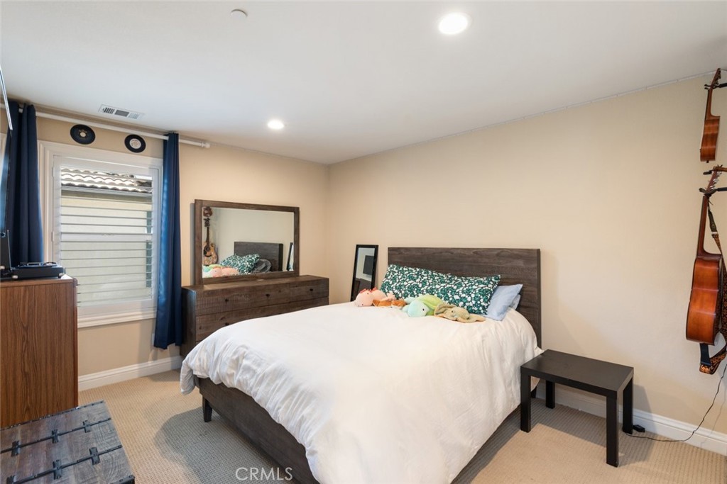 31134 Maverick Lane Temecula, CA 92591 - Photo 8 of 22 a bedroom with a bed and a chair