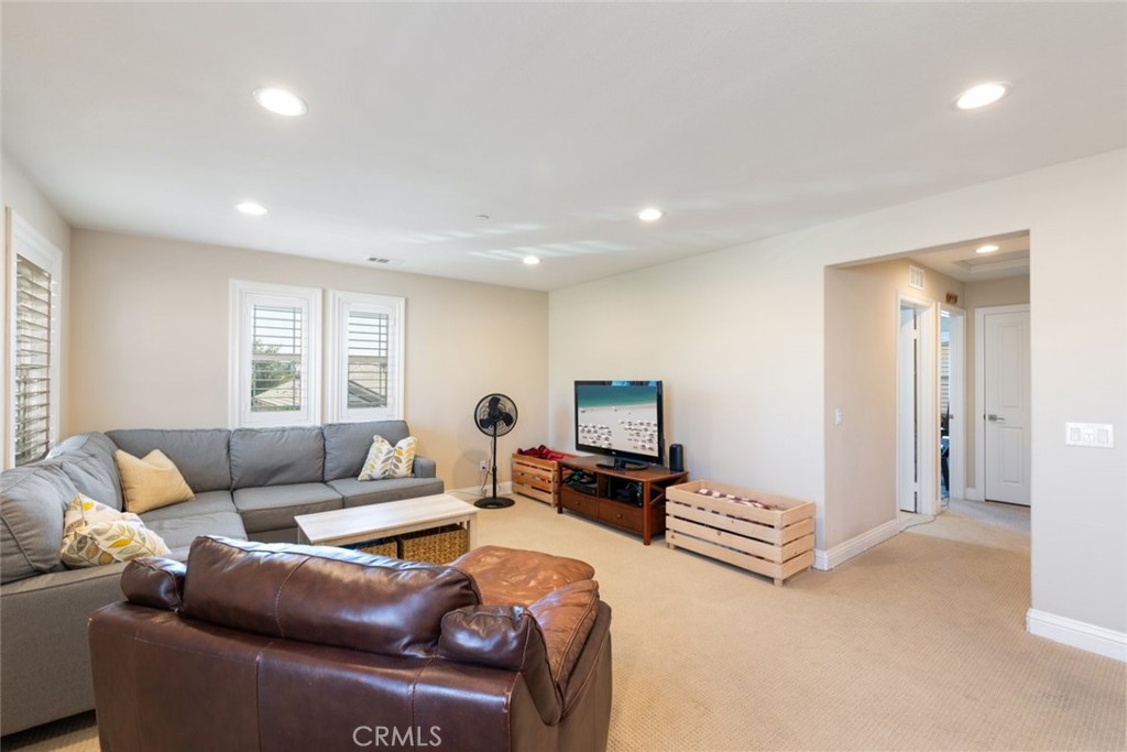 31134 Maverick Lane Temecula, CA 92591 - Photo 8 of 24 a living room with furniture and a flat screen tv