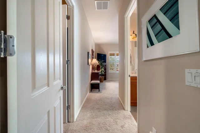 a bathroom with a double vanity sink a large mirror and a bathtub