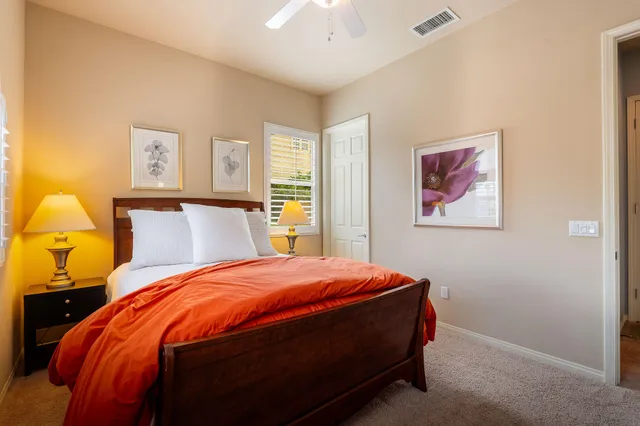 a view of a patio with a table and chairs and potted plants