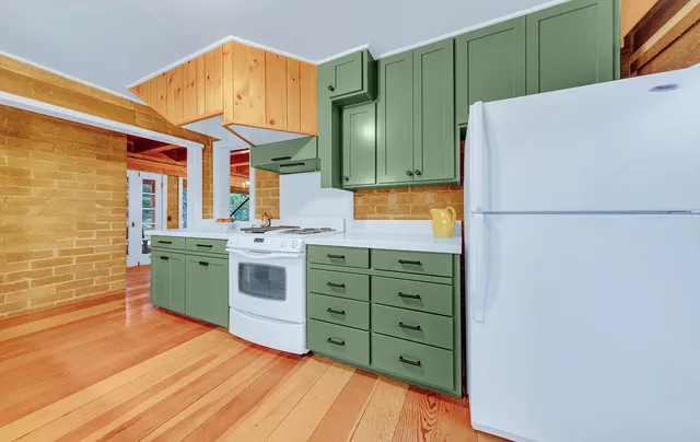 a kitchen with cabinets and white stainless steel appliances