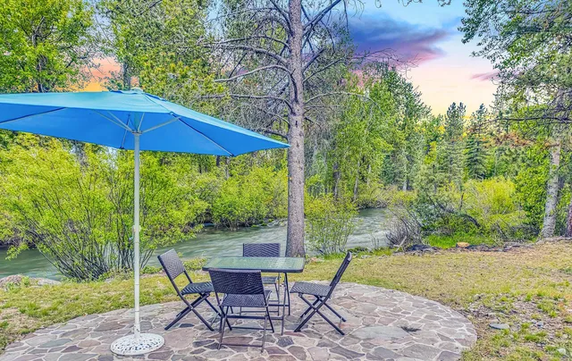 a view of a chair and table in backyard