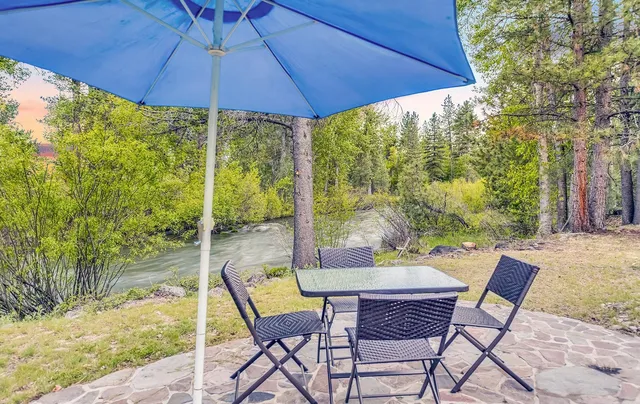 a view of a patio with table and chairs under an umbrella