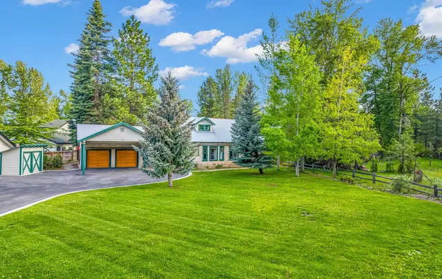 a front view of house with yard and green space