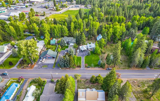 a view of a garden with an ocean from a balcony