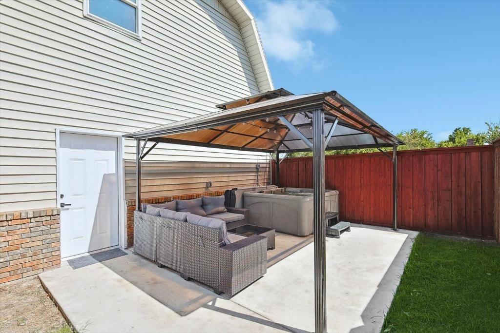 3322 Darby Lane, Unit GUEST Denton, TX 76207 - Photo 21 of 22 a patio with couches and potted plants
