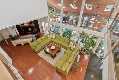 a living room with furniture and floor to ceiling windows