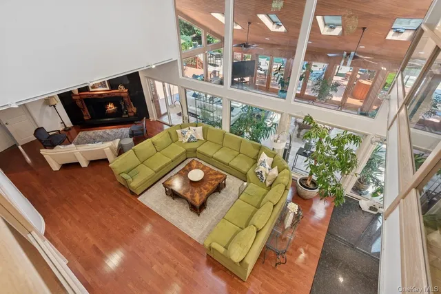 a living room with furniture and floor to ceiling windows