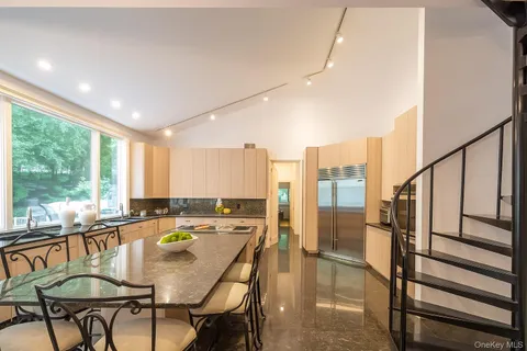 a kitchen with stainless steel appliances granite countertop a sink and a stove