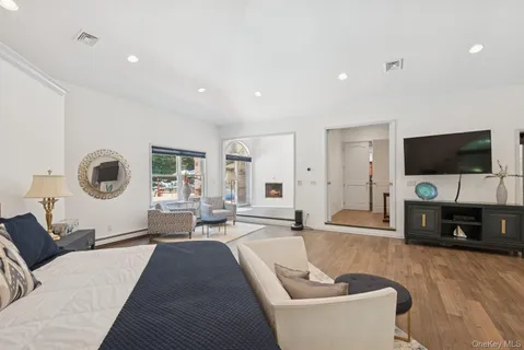 a white bed sitting in a room next to a window