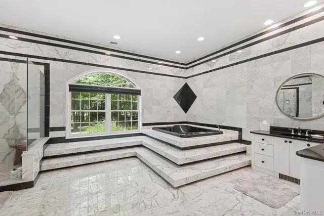 a spacious en suite bathroom with a shower and a bathtub