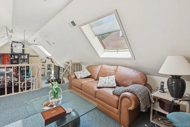 a living room with furniture and a ceiling fan