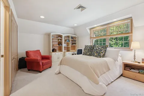 a bathroom with a granite countertop sink a toilet and a mirror